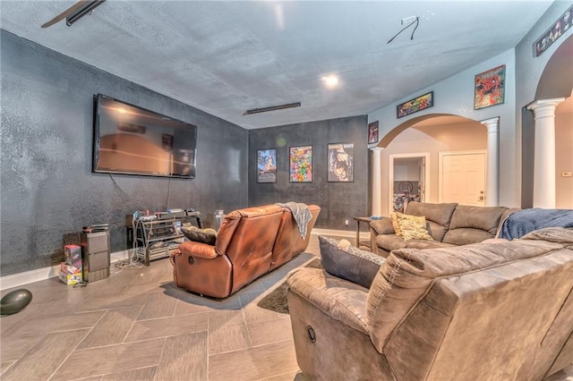 home theater room with decorative columns