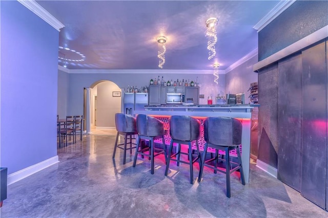 31 Meadow Lakes Ter, Cedartown, GA 30125 - indoor dry bar featuring arched walkways, appliances with stainless steel finishes, concrete floors, crown molding, and baseboards