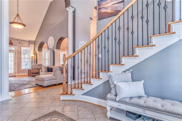 31 Meadow Lakes Ter, Cedartown, GA 30125 - staircase with high vaulted ceiling, arched walkways, ornate columns, tile patterned flooring, and baseboards