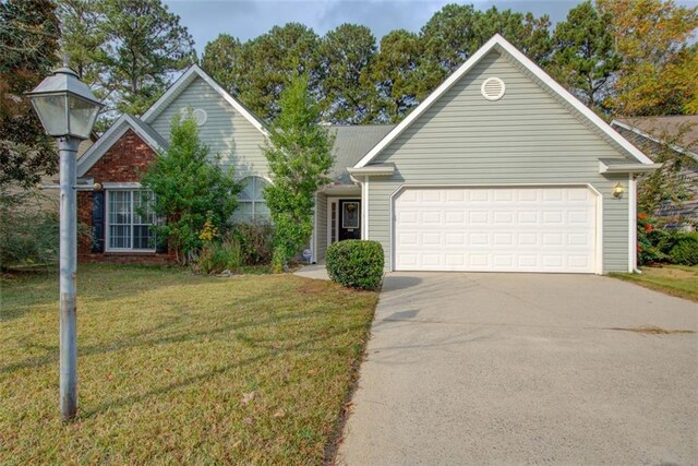 view of front of property with a front yard and a garage