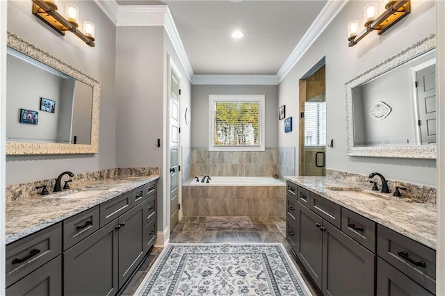 bathroom featuring vanity, hardwood / wood-style flooring, separate shower and tub, and crown molding