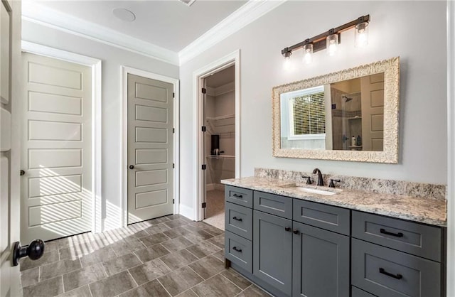 bathroom with vanity, an enclosed shower, and ornamental molding