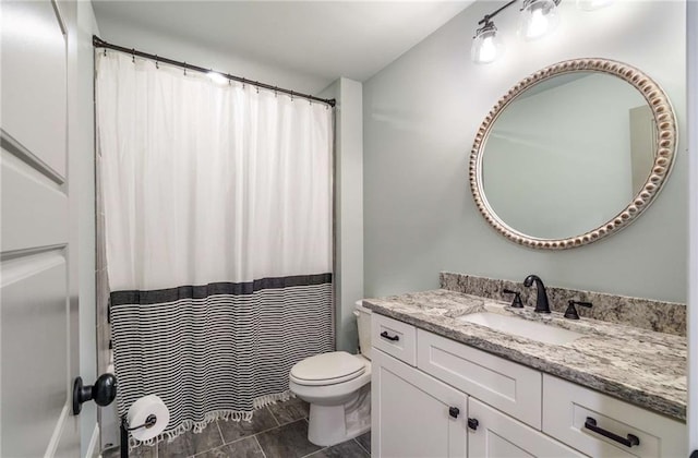 bathroom featuring tile patterned floors, vanity, and toilet