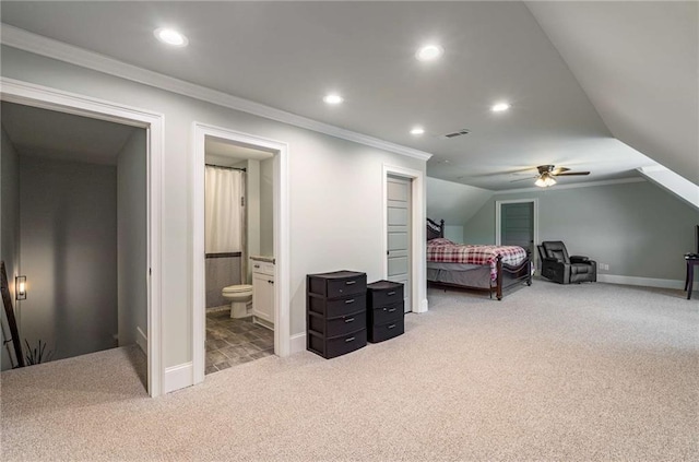 carpeted bedroom featuring connected bathroom, ceiling fan, crown molding, and vaulted ceiling