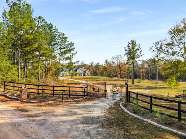 view of street featuring a gated entry, driveway, and a gate