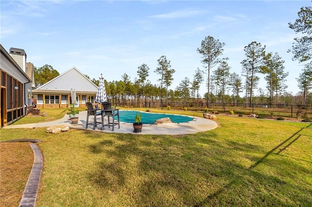 view of swimming pool with a patio and a lawn