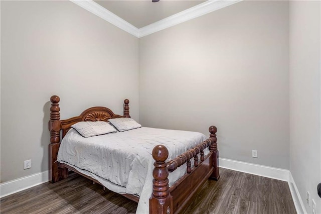 bedroom featuring dark hardwood / wood-style floors and crown molding