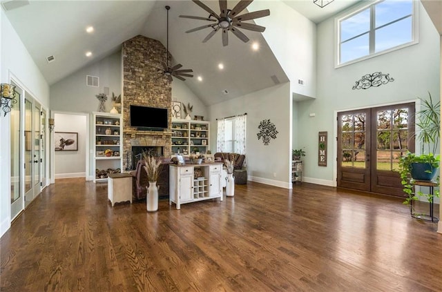 living room with dark hardwood / wood-style flooring, french doors, high vaulted ceiling, and a fireplace