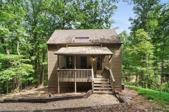 view of front of home featuring a porch and a shingled roof