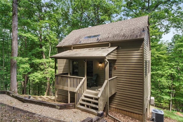 view of front of house with a porch and central air condition unit