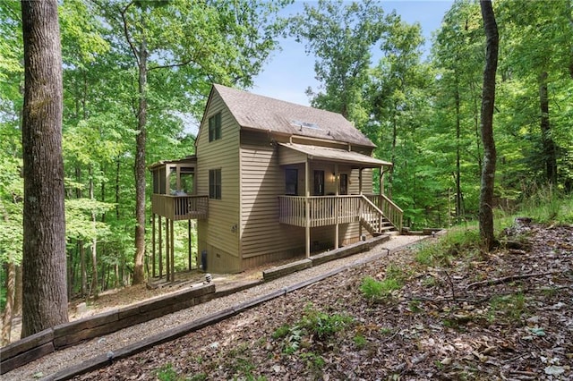 back of property with a balcony