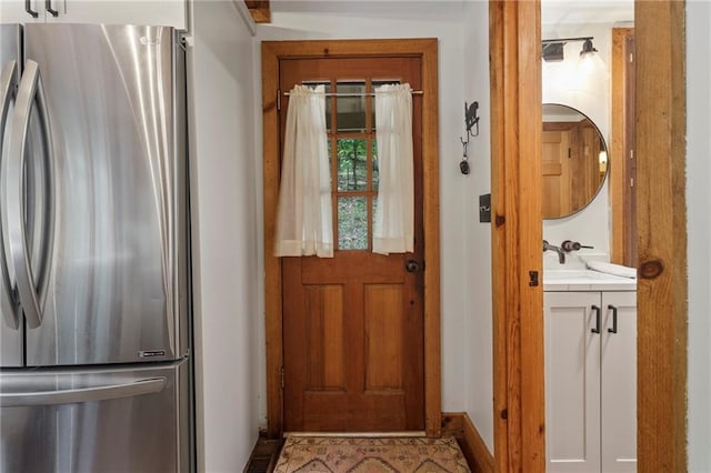 doorway to outside with a sink