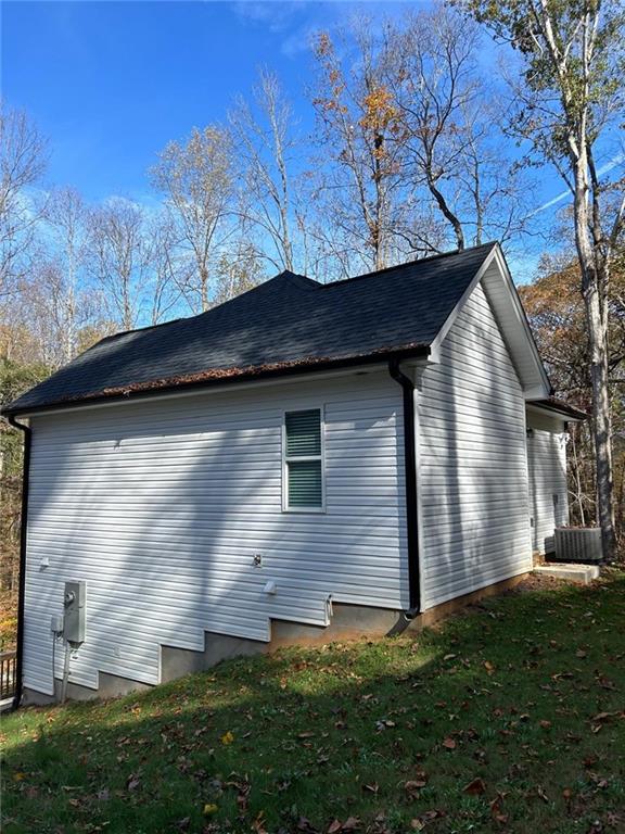 view of side of property with a lawn