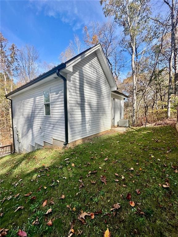 view of property exterior featuring cooling unit and a lawn