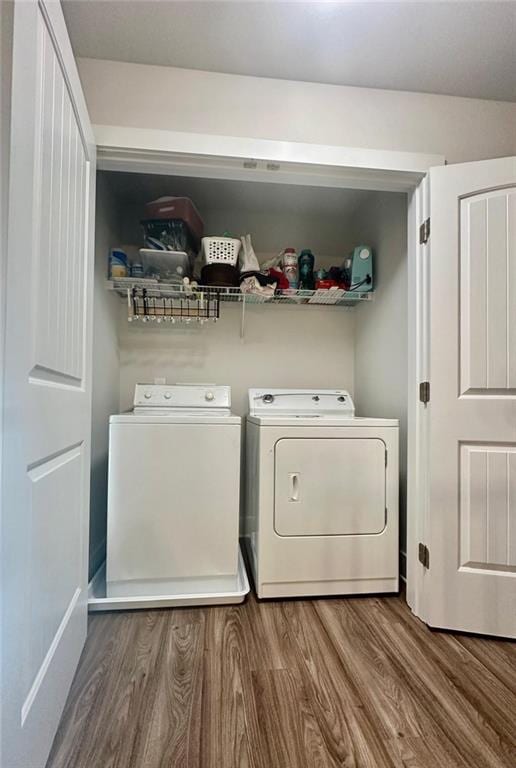 laundry room with separate washer and dryer and wood-type flooring