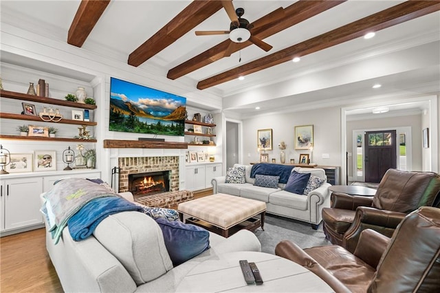 5821 Abbey View Ct, Clermont, GA 30527 - living area with beam ceiling, ornamental molding, ceiling fan, a fireplace, and light wood-style flooring