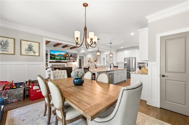 5821 Abbey View Ct, Clermont, GA 30527 - dining area with a chandelier, recessed lighting, ornamental molding, a decorative wall, and wood finished floors