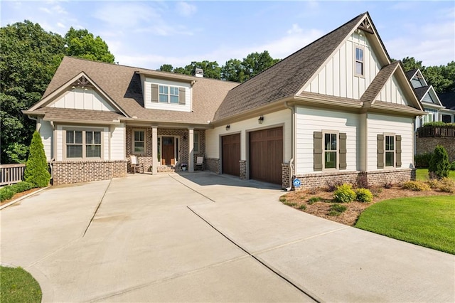 5821 Abbey View Ct, Clermont, GA 30527 - craftsman house featuring a porch, brick siding, board and batten siding, and a garage