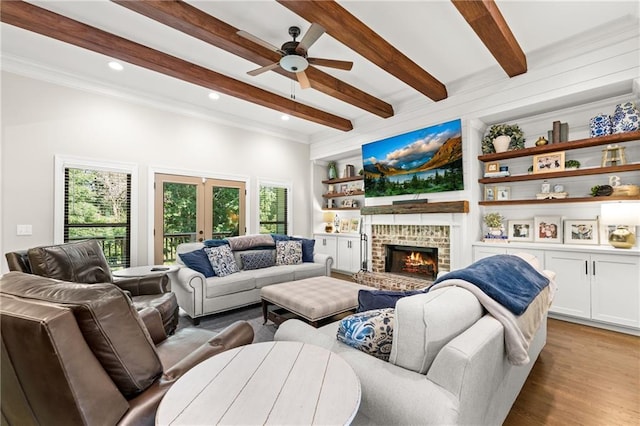 5821 Abbey View Ct, Clermont, GA 30527 - living room with beam ceiling, a ceiling fan, french doors, a fireplace, and wood finished floors