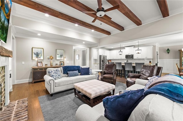 5821 Abbey View Ct, Clermont, GA 30527 - living area featuring a ceiling fan, beamed ceiling, wood finished floors, recessed lighting, and crown molding
