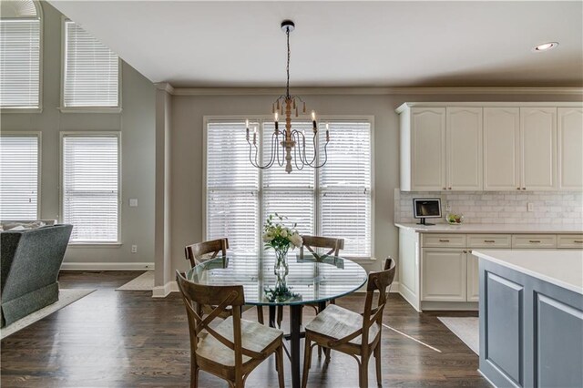 dining room featuring a wealth of natural light, baseboards, an inviting chandelier, and dark wood-style floors