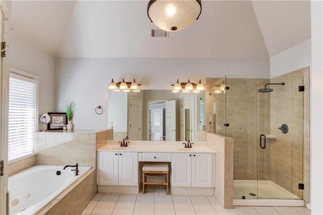 full bathroom with lofted ceiling, visible vents, and a sink