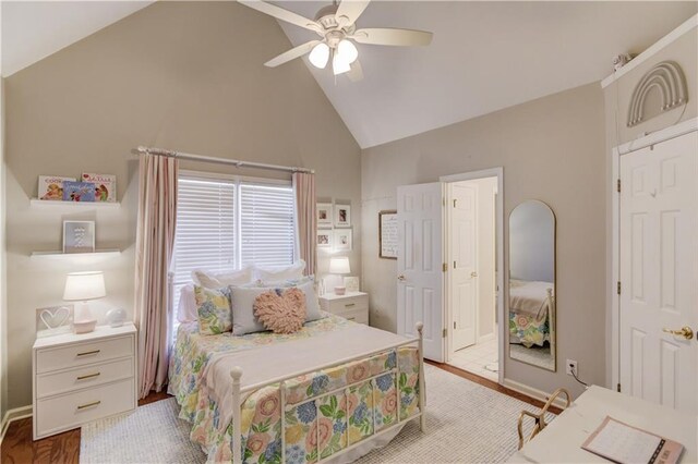 bedroom with light wood finished floors, baseboards, high vaulted ceiling, and a ceiling fan