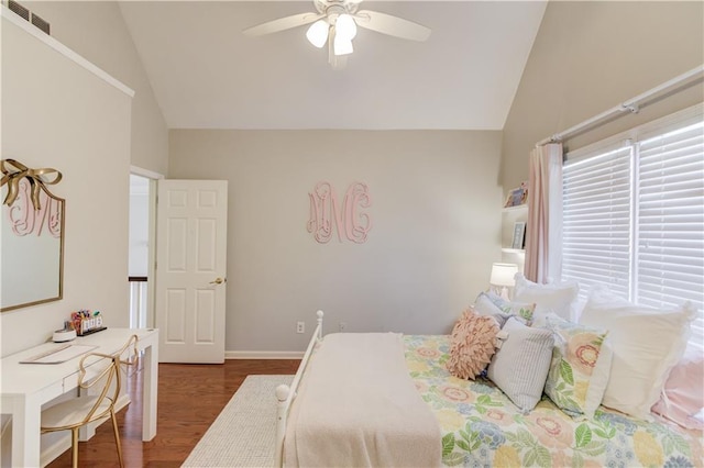 bedroom featuring visible vents, wood finished floors, baseboards, and vaulted ceiling