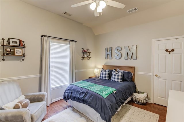 bedroom featuring vaulted ceiling, wood finished floors, and visible vents