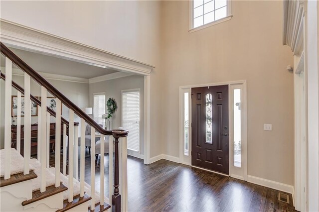 entryway with visible vents, baseboards, and dark wood-style floors