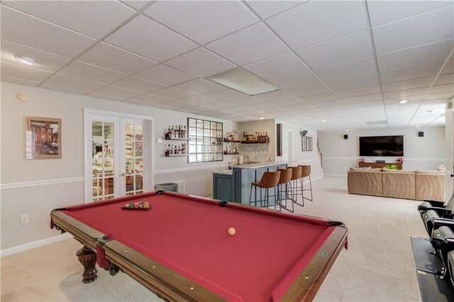 game room with french doors, baseboards, carpet, and a dry bar