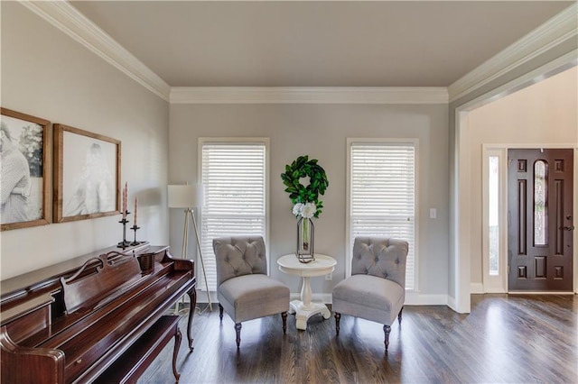 sitting room featuring crown molding, baseboards, and wood finished floors