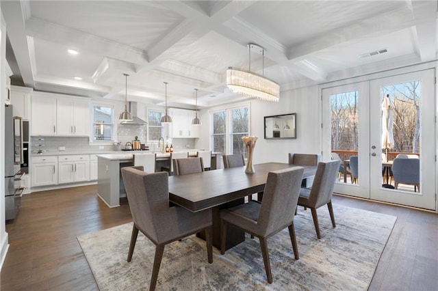 dining room featuring french doors, beam ceiling, dark wood finished floors, visible vents, and coffered ceiling