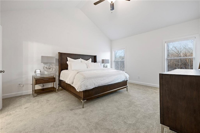 bedroom with baseboards, high vaulted ceiling, multiple windows, and light colored carpet