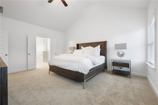 bedroom with high vaulted ceiling, carpet flooring, baseboards, and ensuite bathroom