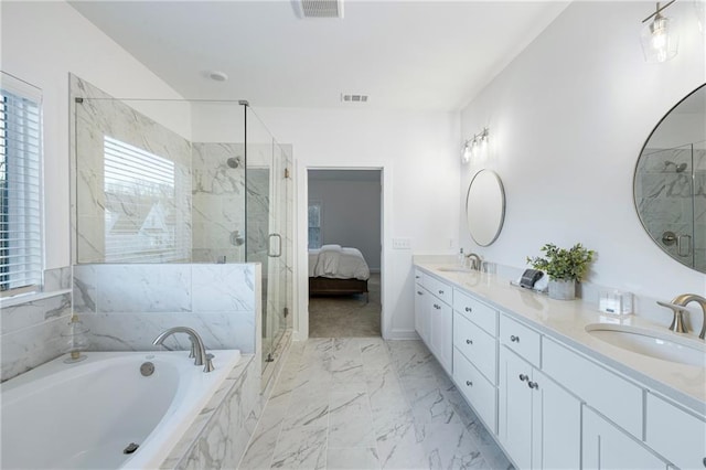 ensuite bathroom with marble finish floor, a garden tub, a marble finish shower, double vanity, and a sink