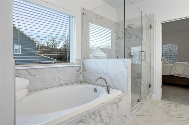 bathroom with a garden tub, ensuite bath, a marble finish shower, and marble finish floor