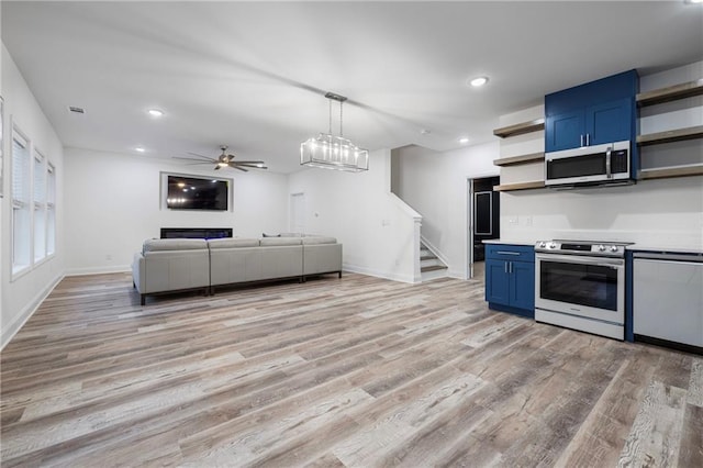 kitchen with blue cabinets, stainless steel appliances, light wood-style floors, open shelves, and recessed lighting