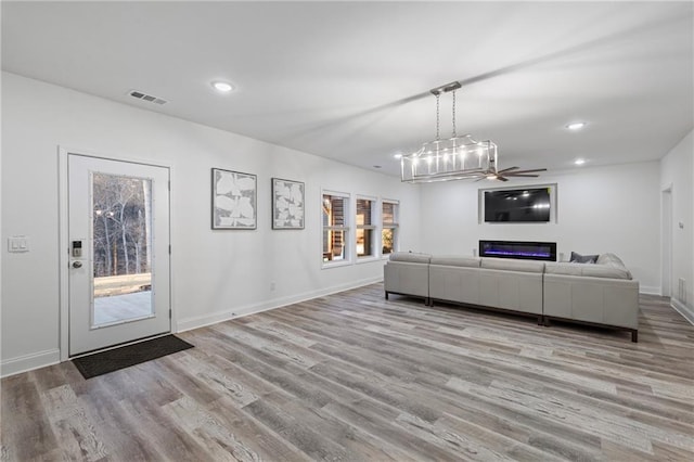 unfurnished living room featuring visible vents, baseboards, wood finished floors, and recessed lighting