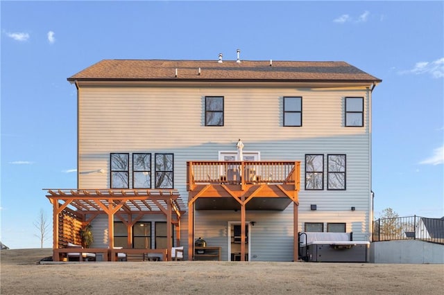 rear view of property with a pergola