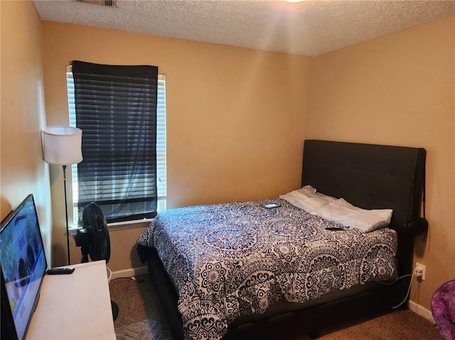 carpeted bedroom featuring a textured ceiling