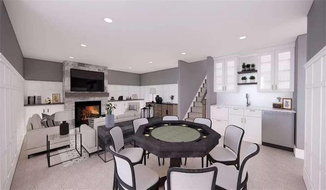 carpeted dining room with a fireplace