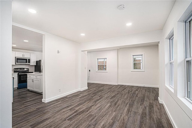 unfurnished living room featuring dark hardwood / wood-style floors