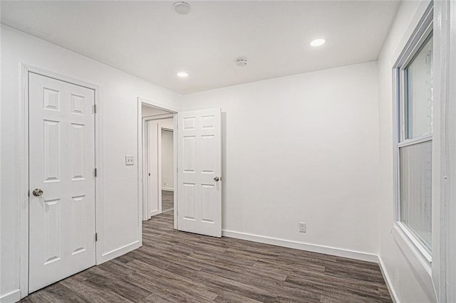 unfurnished bedroom featuring dark hardwood / wood-style floors