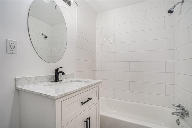 bathroom featuring vanity and tiled shower / bath