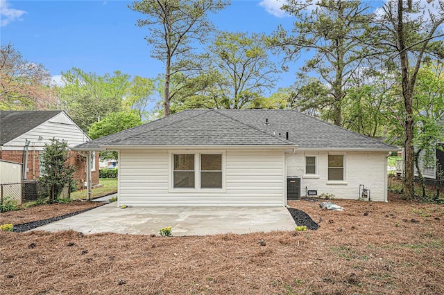 back of property with central AC and a patio