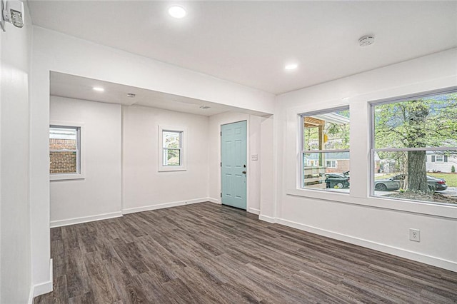 spare room featuring dark wood-type flooring