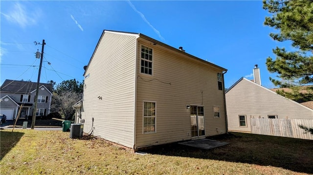 rear view of house featuring a yard and cooling unit