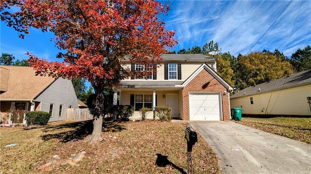 view of property featuring a garage and a front lawn