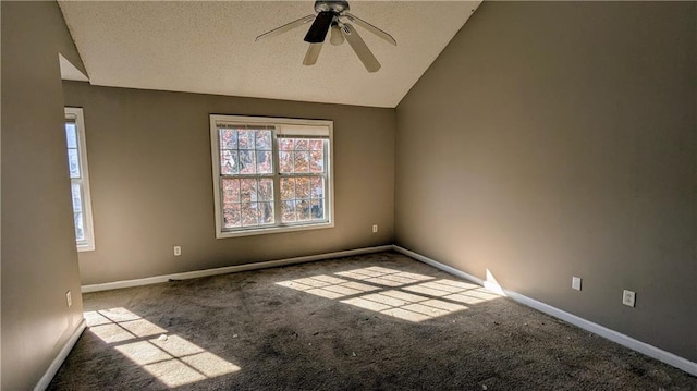 carpeted empty room with ceiling fan, lofted ceiling, and a textured ceiling